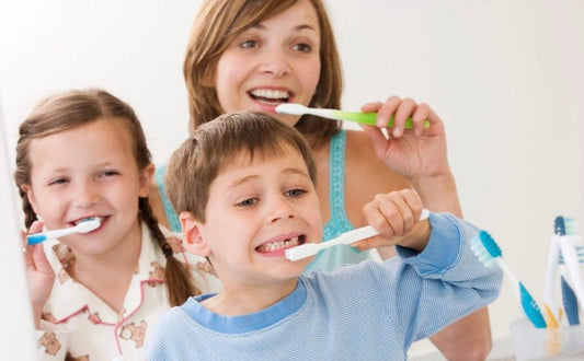Child brushing teeth with a colorful toothbrush during winter to promote brushing habits